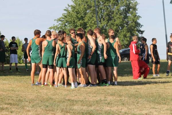 Runners huddle together to rally the team