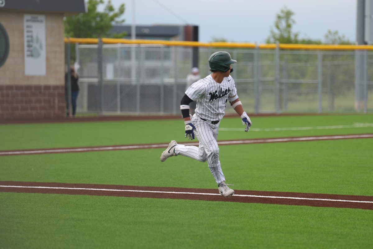 On May 6, during the game against BVNW, junior Brody Shinkle runs to first base after hitting the ball. 