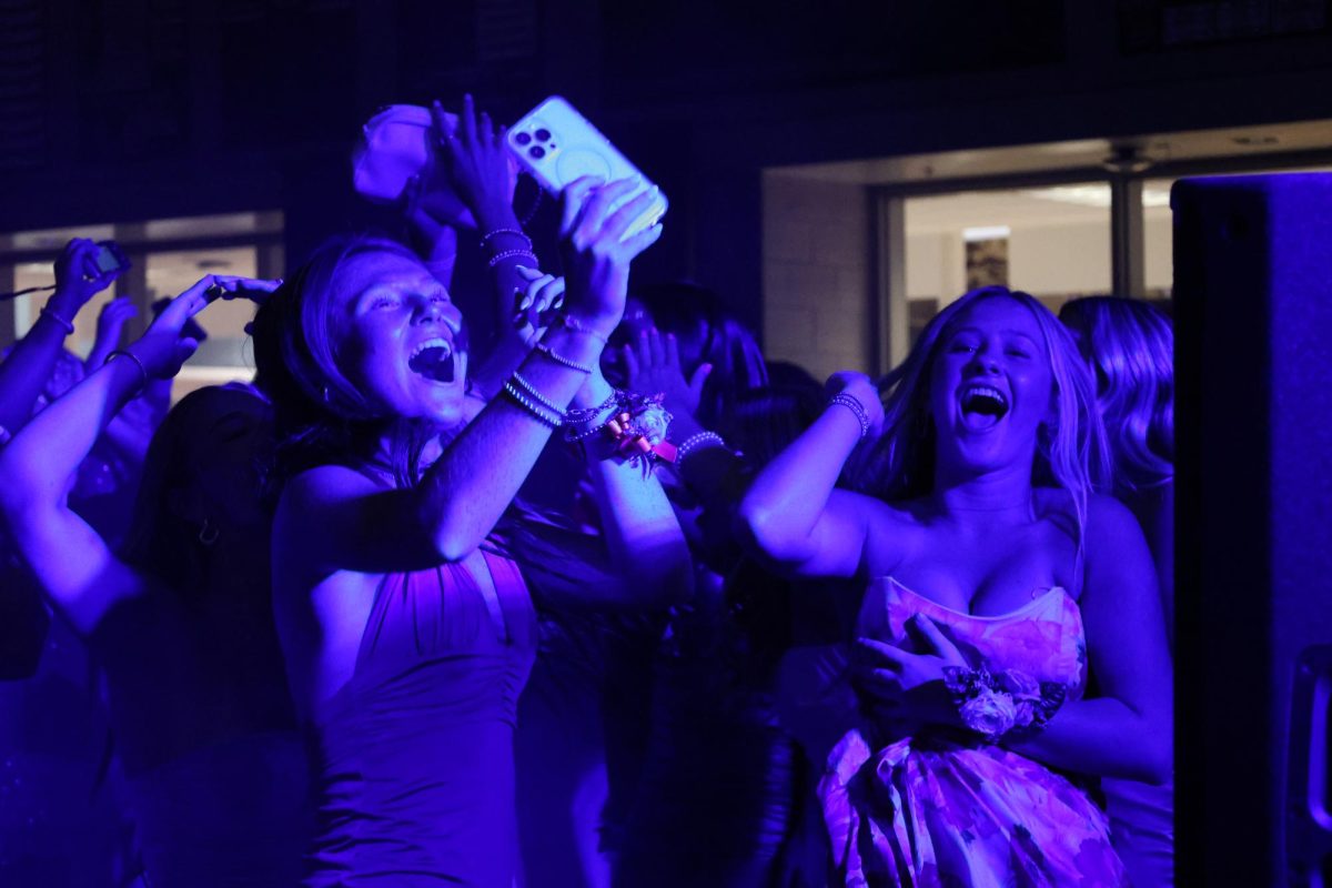 Seniors Jillian Hermann and Sophia Harmon take photos and dance on Sept. 14.