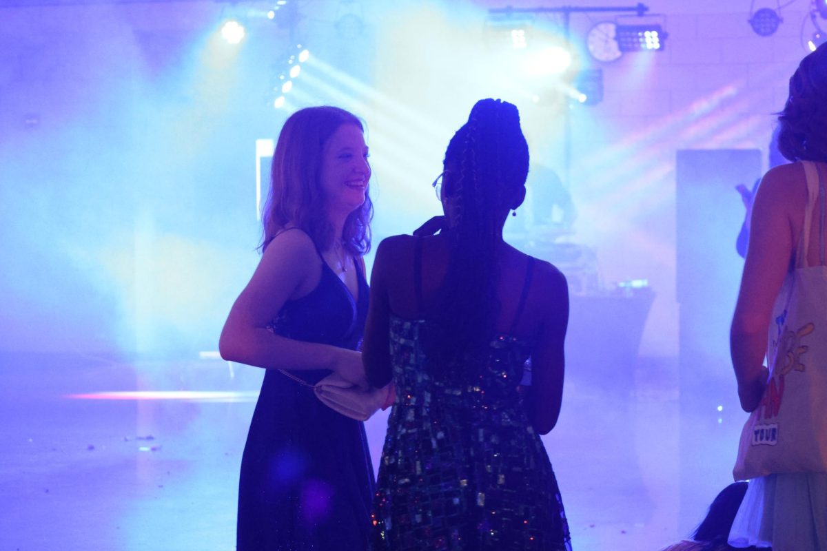 Sophomores Kerry Espelien and Dara Onibonoje laugh during the Homecoming dance on Sept. 14. 